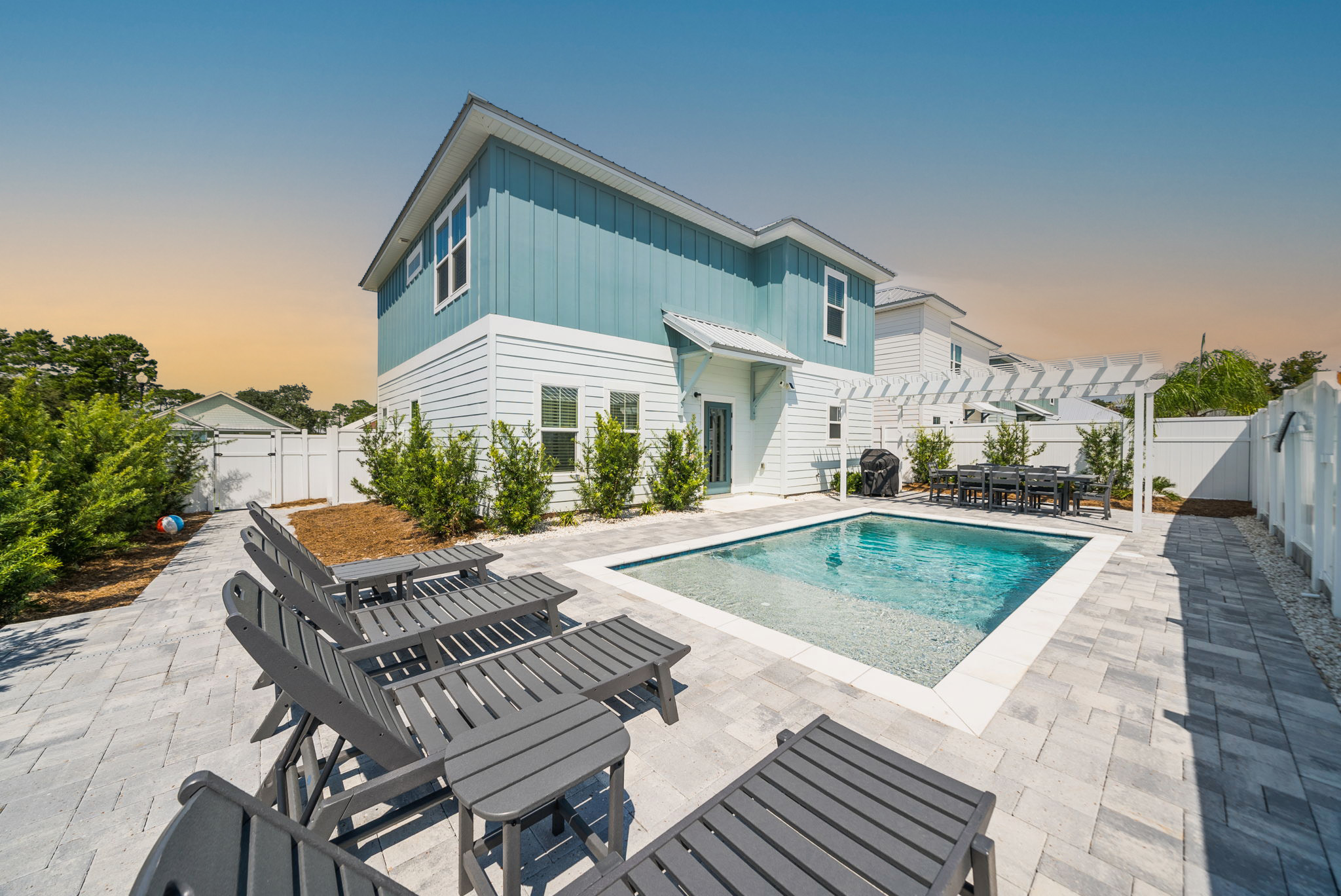 Luxury vacation rental pool glowing at twilight — managed by Sunset Luxury Properties